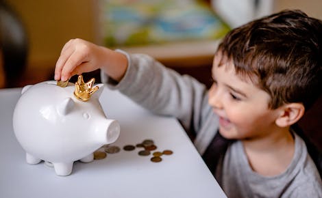 Kid and piggy bank